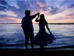 Couple dancing on beach at dusk