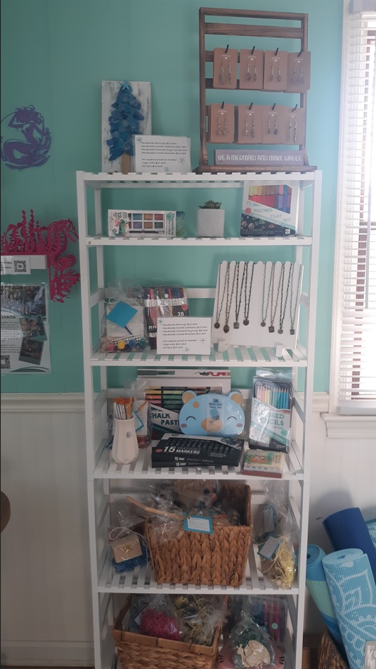 Shelf of items for sale at Mindful Mermaid