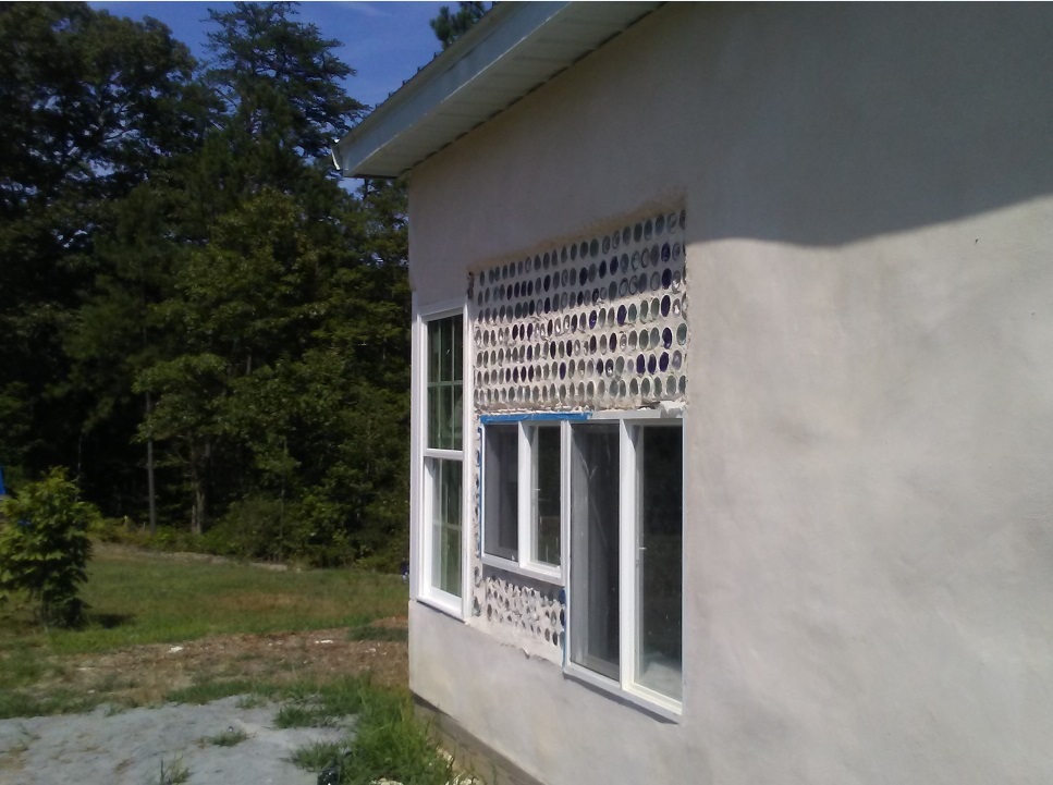 strawbale barn with built-in wine bottles