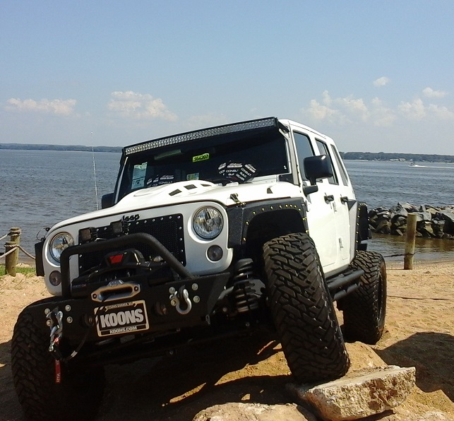 white jeep on rocks